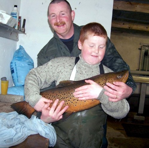 Sean McWilliams and Francis Loane with a huge dollagahan captured during electrofishing